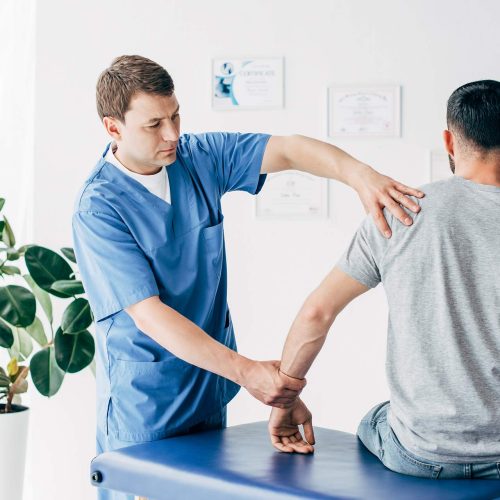 physiotherapist-massaging-arm-of-patient-on-massag-2024-11-01-05-24-00-AEMUJS7.jpg